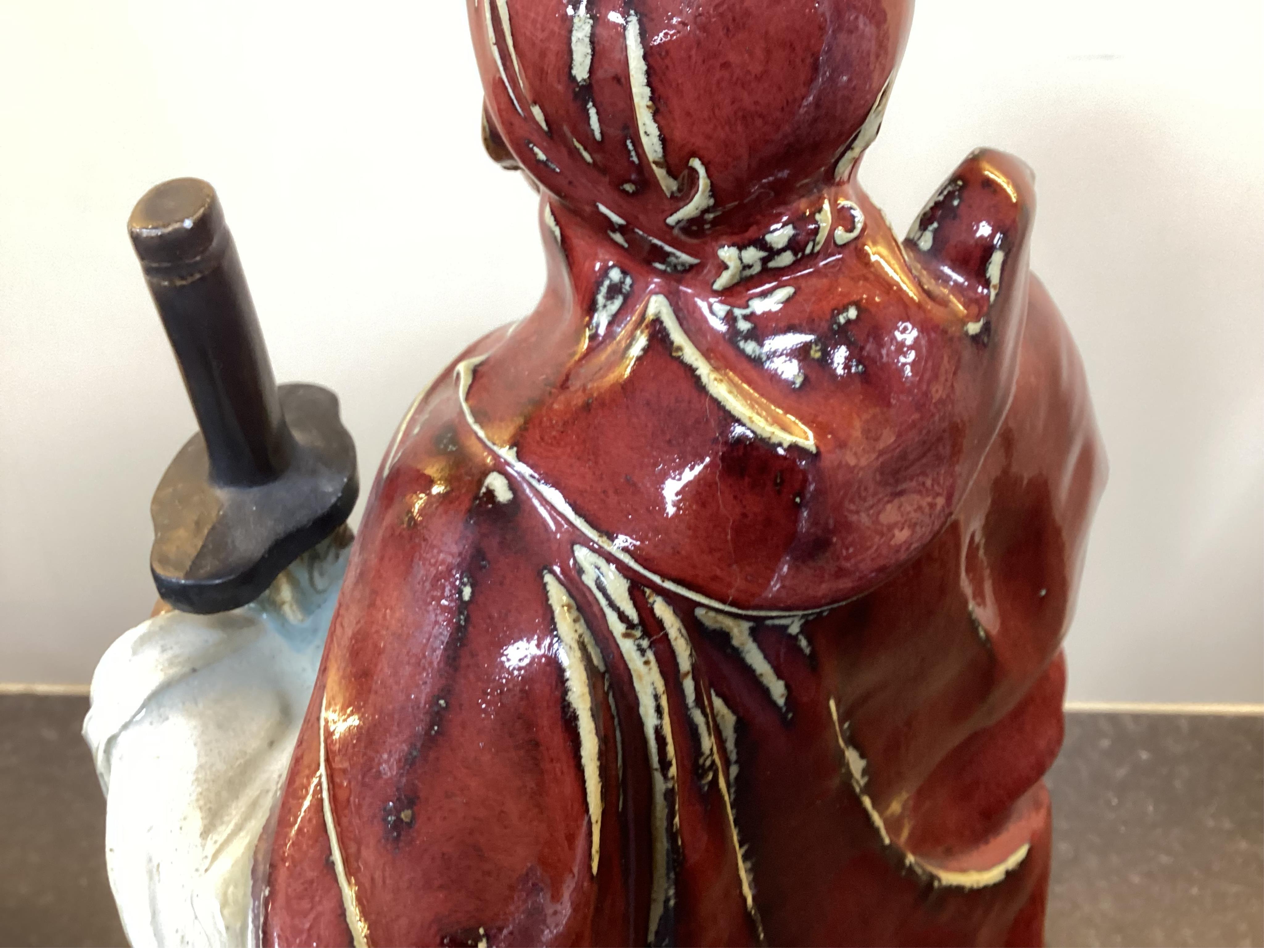 A large Chinese Shiwan stoneware figure of a warrior, 20th century